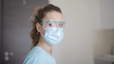 Healthcare worker wear a face mask and protective glasses