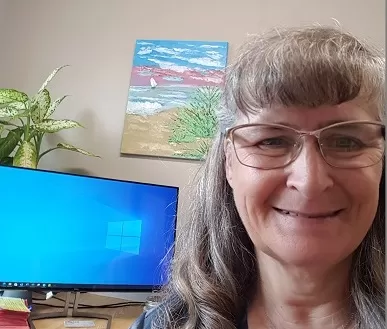 Sharon smiling in her home office