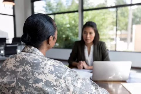 woman veteran in uniform with career counselor