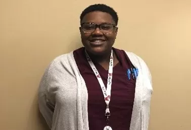 photo of Tiona who moved from food service jobs to a health care career thanks to Dislocated Worker