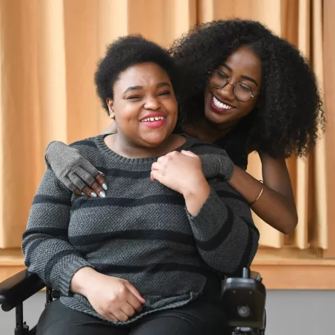 Woman with disability and direct care professional working with her