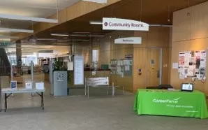 CareerForce Corner in a Minnesota library, with a table covered in a CareerForce branded table topper and CareerForce signs