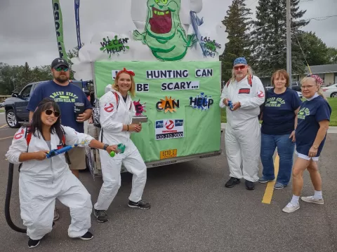RMCEP staff in front of a truck decorated with a Ghostbusters theme and writing Job Hunting Can Be Scary. Who You Gonna Call? RMCEP 320-232-2000