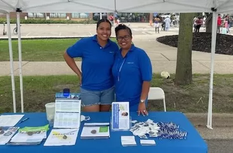 two CareerForce staff members at table with resources
