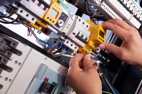 close up of hands of person doing electrical wiring