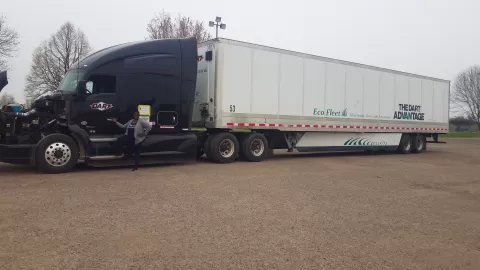 Stacy standing in front of semi truck