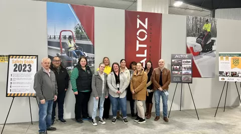 photo of people standing in front of Altoz sign