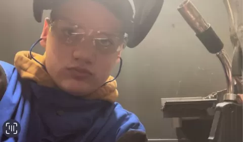 Person wearing a welding helmet 