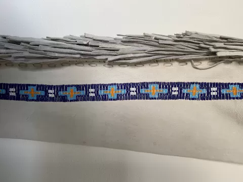 close up of beads sewn onto leather