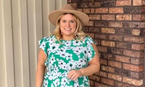 photo of smiling person wearing a hat