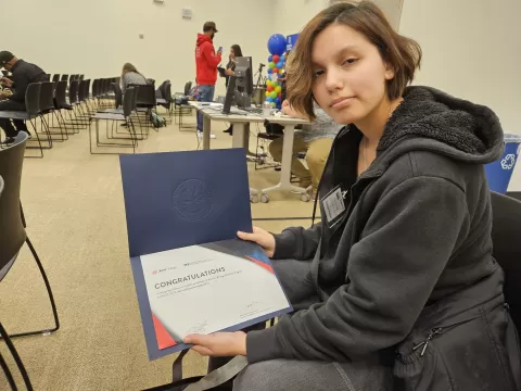 photo of person holding a certificate