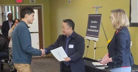 Daniel receiving certificate at Hired Drive for 5 Semiconductor Manufacturing graduation
