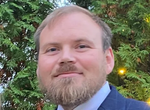 photo of a person with trees in the background