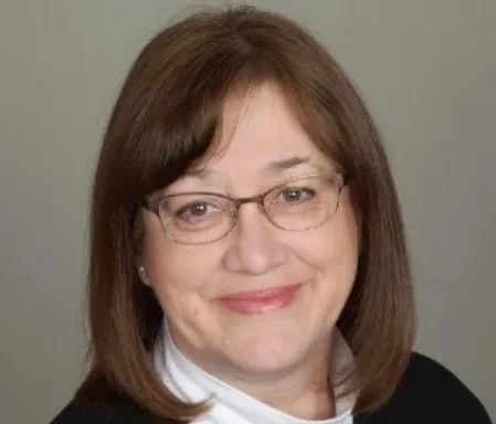 photo of smiling person wearing glasses