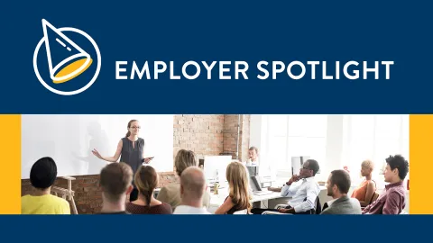 image of many people sitting in a room with a person standing in front of the room and the words 'Employer Spotlight"